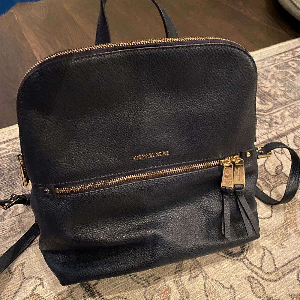 Navy-blue back pack purse. Michael Kors. No flaws, tears or wear marks.